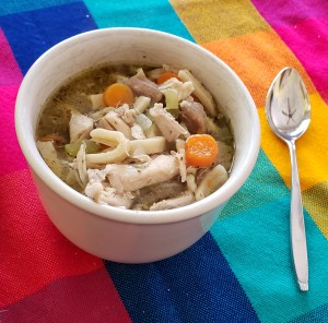 Homemade chicken noodle soup with carrots, onions, celery, and big thick noodles.
